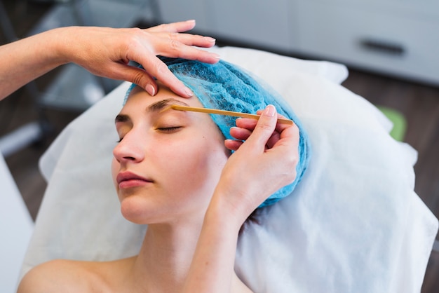 Free photo girl receiving facial treatment in a beauty salon