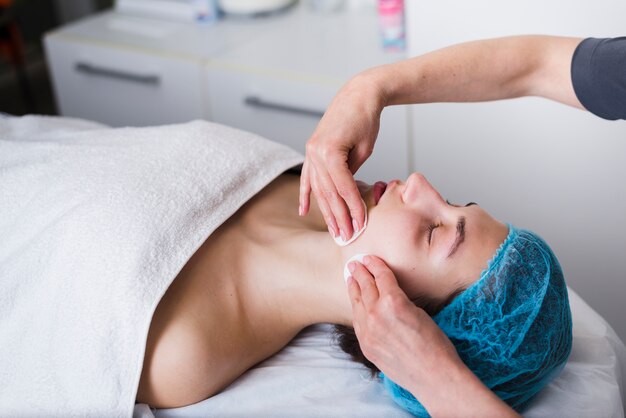 Girl receiving facial treatment in a beauty salon