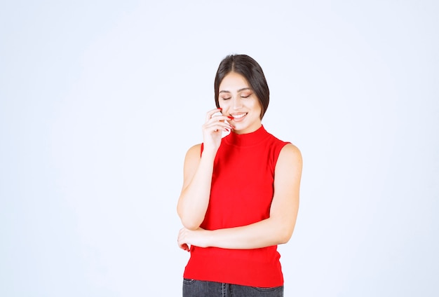 Girl in red shirt giving lovely and seductive poses.