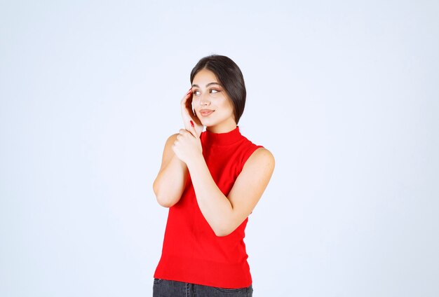 Girl in red shirt giving lovely and seductive poses.