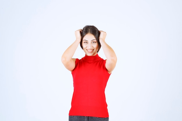 Girl in red shirt giving neutral, positive and appealing poses.