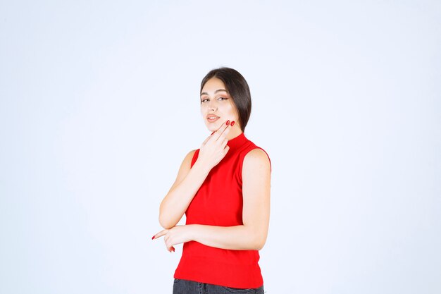 Girl in red shirt giving neutral, positive and appealing poses.