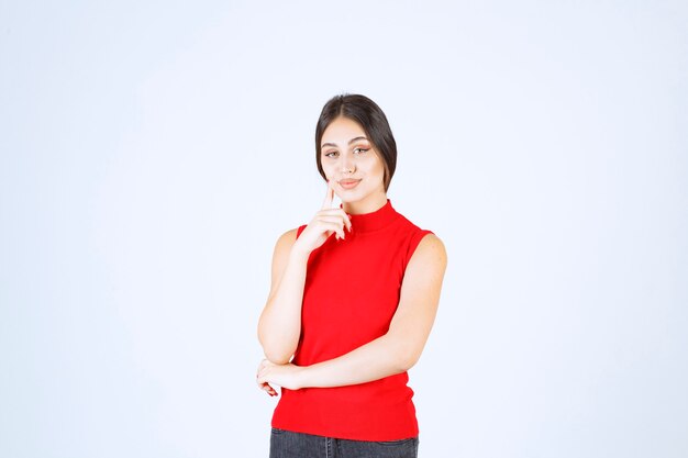 Girl in red shirt giving neutral, positive and appealing poses.