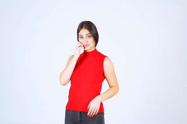 Girl in red shirt giving neutral, positive and appealing poses.