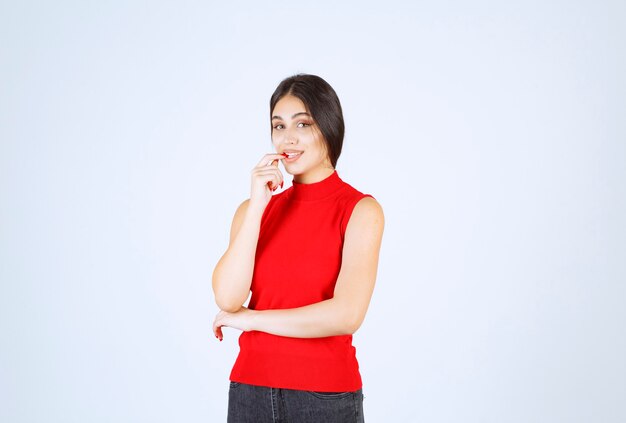 Girl in red shirt giving neutral, positive and appealing poses.