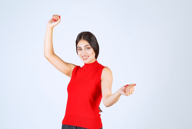 Girl in red shirt giving neutral, positive and appealing poses.