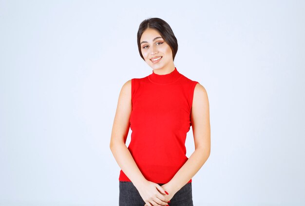 Girl in red shirt giving neutral, positive and appealing poses.