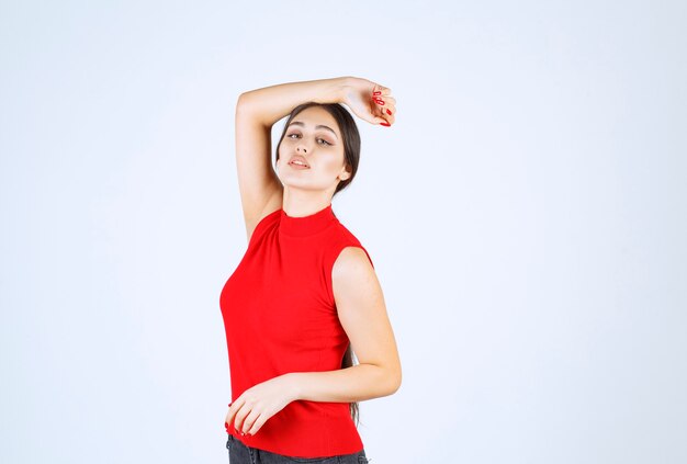 Girl in red shirt giving neutral, positive and appealing poses.