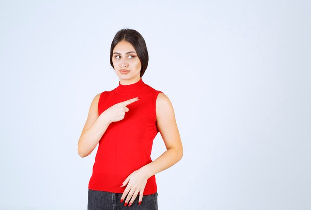 Girl in the red shirt pointing at right side.