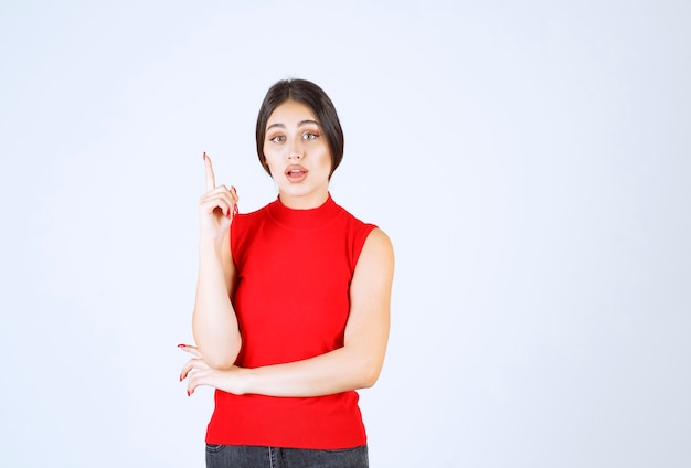 Girl in red shirt thinking and analizing.