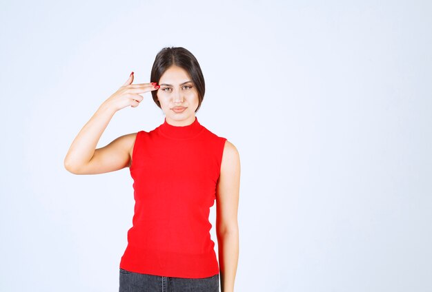 Girl in red shirt thinking and analizing.