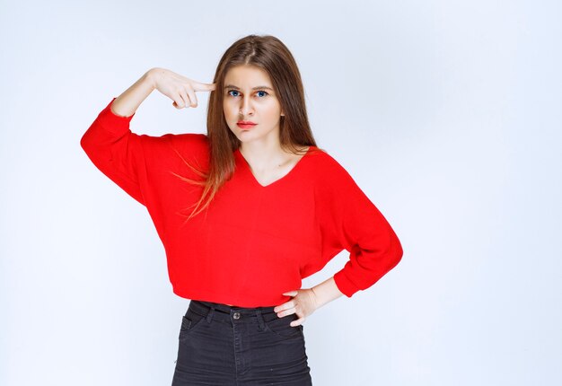 Girl in red shirt thinking and brainstorming. 