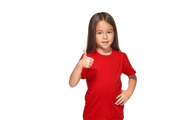 Girl in red t-shirt shows her hand with thumb in red t-shirt isolated on white background