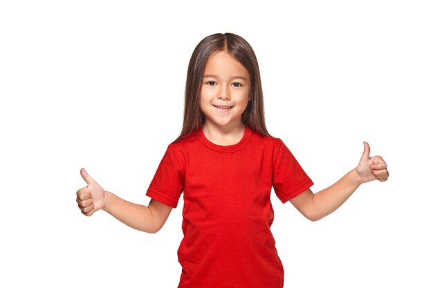 Girl in red t-shirt shows her hands with thumbs in red t-shirt isolated on white background