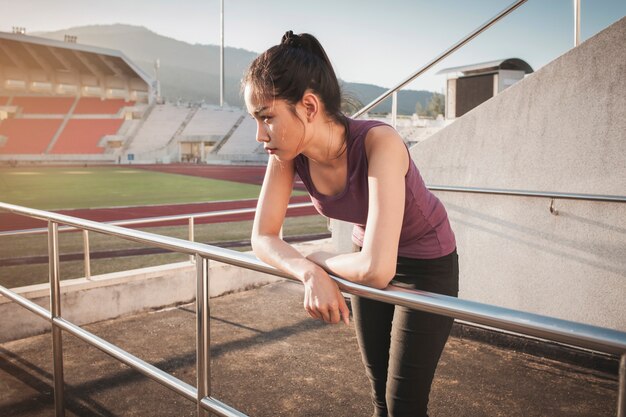 Girl resting on a metal railing