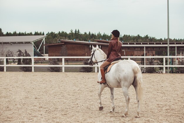 the girl rides a horse