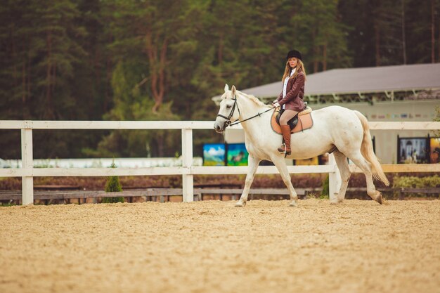 the girl rides a horse