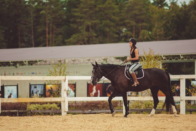 the girl rides a horse