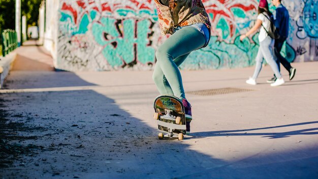 Girl riding skateboard making stunts