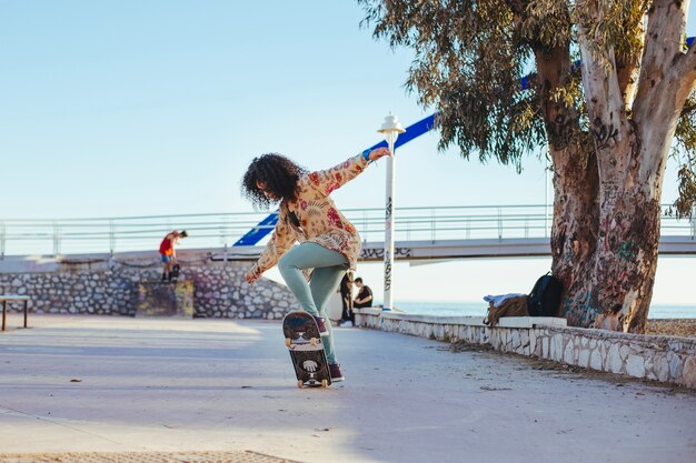 Girl riding skateboard making tricks