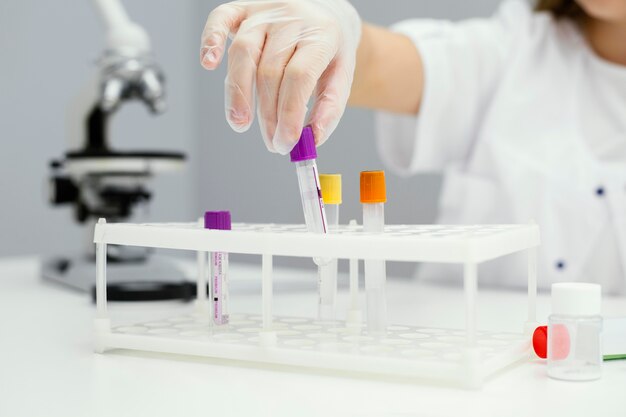 Girl scientist with test tubes and lab coat