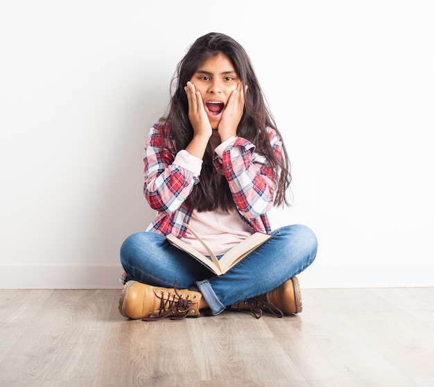 Girl screaming with hands on face