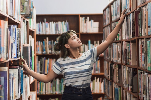 Girl searching bookshelf