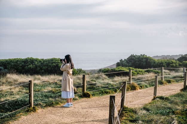 girl shoot photo in walkway and field