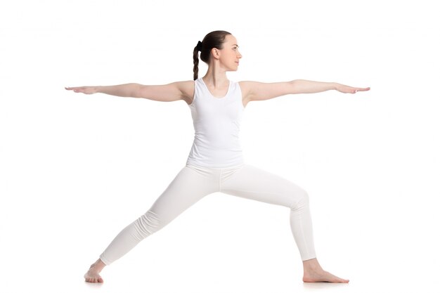 Girl showing her balance in yoga class