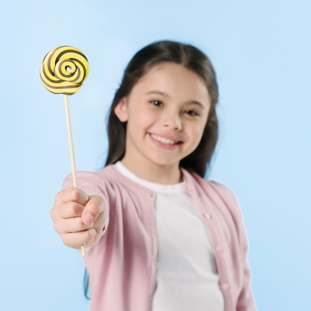 Girl showing lollipop instudio