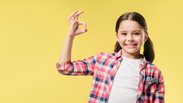 Girl showing okay sign in studio