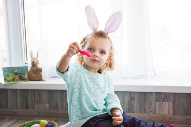 Girl showing paper rabbit