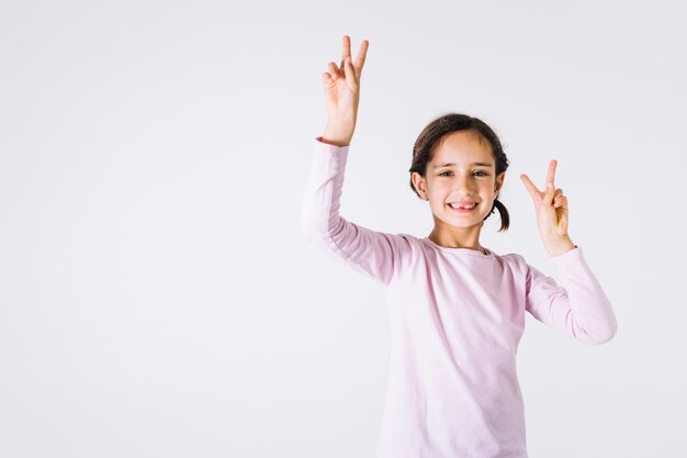 Girl showing peace gesture