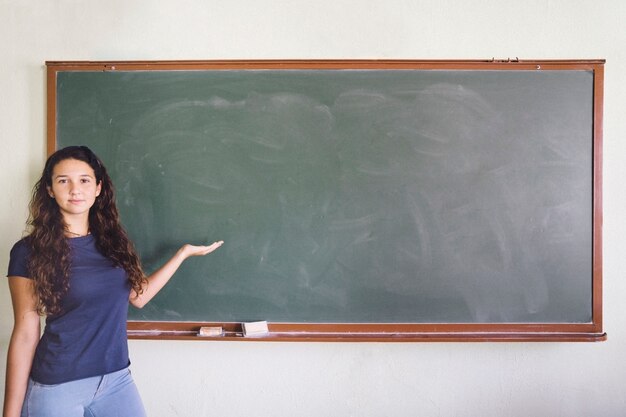 Girl showing something on the blackboard