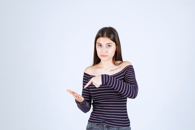 Girl showing something in her open hand. 