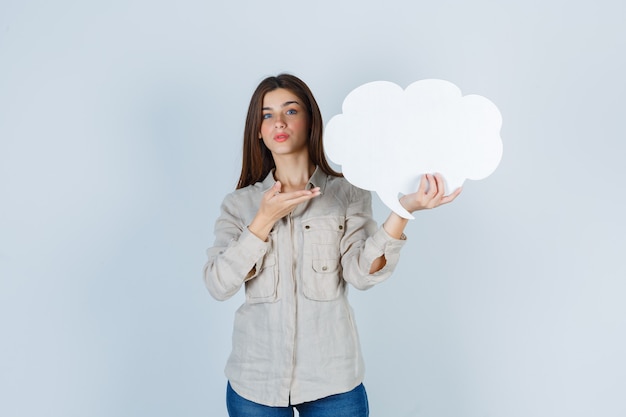 girl showing speech bubble in shirt and looking hesitative.