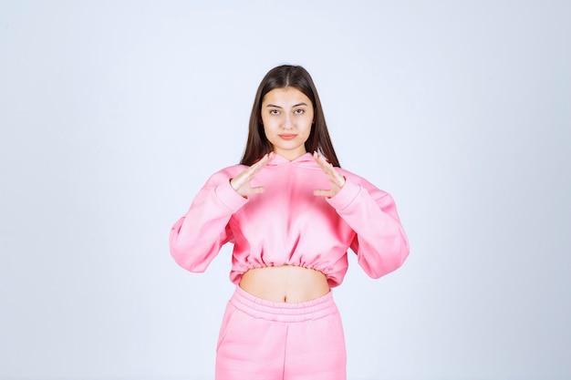 Girl showing triangle sign in the hand