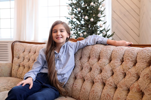 Girl sits on couch