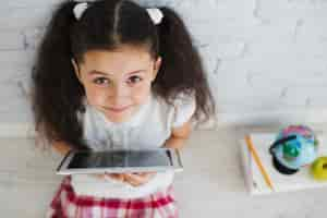 Free photo girl sitting holdgin laptop looking up