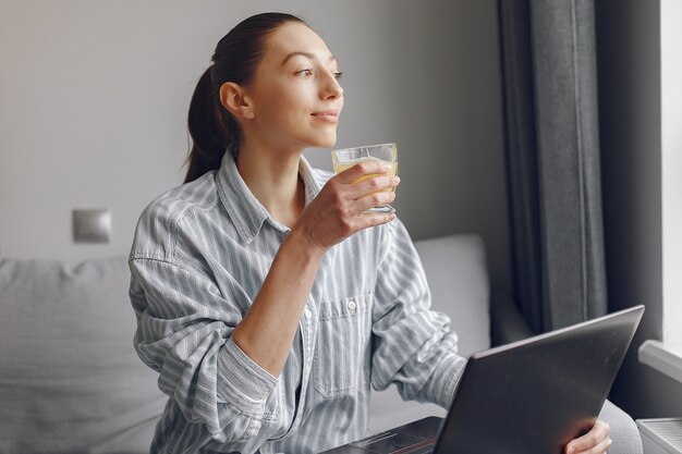 Girl sitting at home and use the laptop