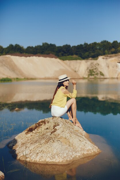 Girl sitting near river