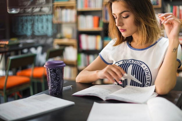 Free photo girl sitting at table with notebooks