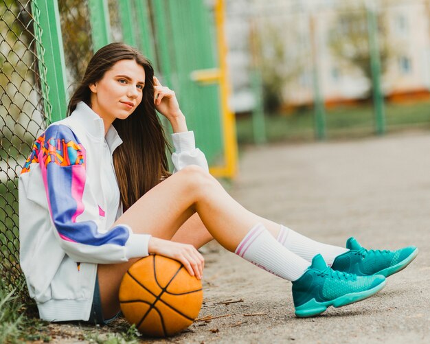 Girl sitting with basketball