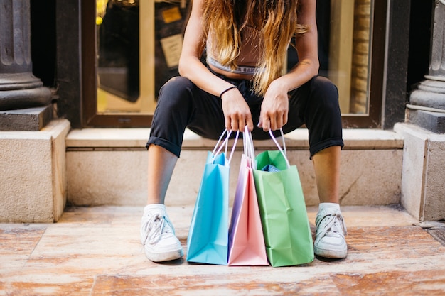 Free photo girl sitting with buyings