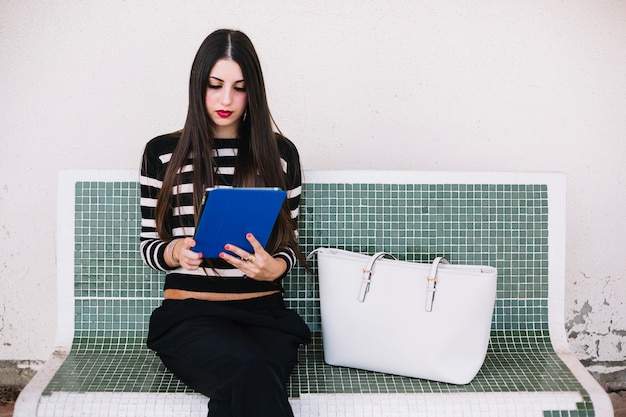 Girl sitting with tablet