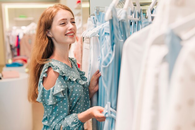 Girl smiling and checking clothes
