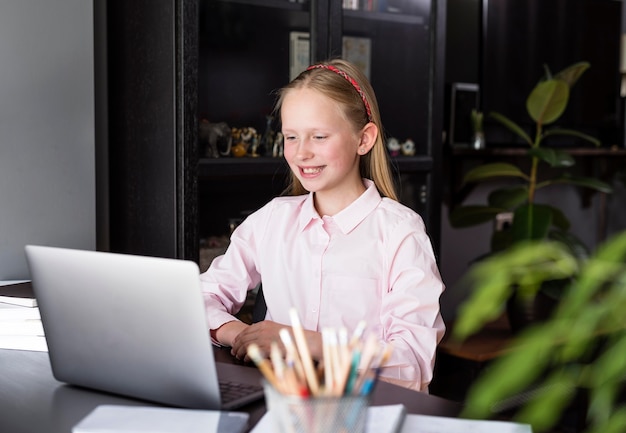 Free photo girl smiling at her colleagues from home