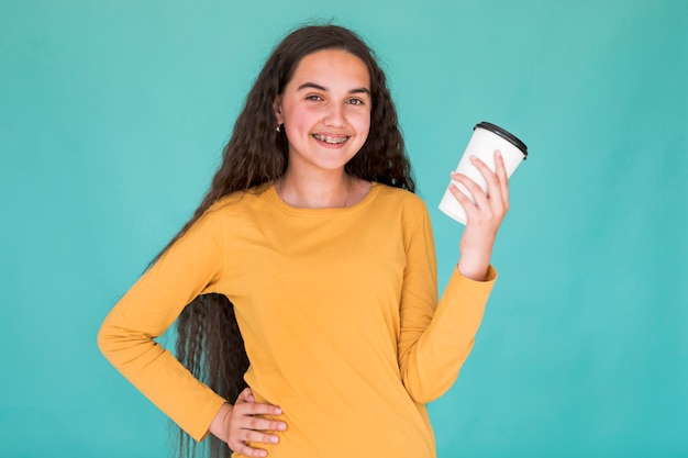 Girl smiling while holding her drink