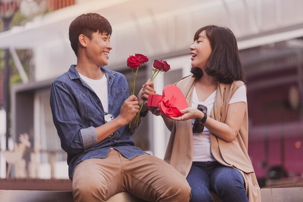 Girl smiling with a box of chocolates and roses