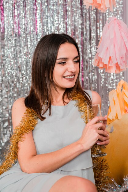 Girl smiling with champagne at a new year party